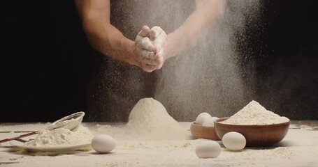 The man clapped his hands and shook the flour
