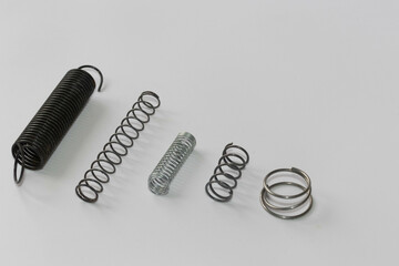Fototapeta premium Chrome metal spring. Metal extension spring, machine part.