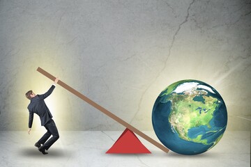 Businessman lifting the earth globe in challenge concept - obrazy, fototapety, plakaty