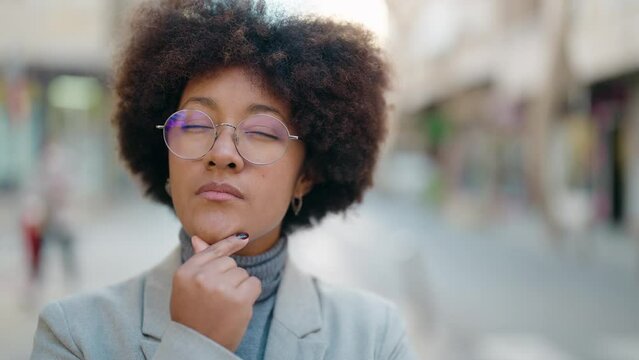 African american woman with doubt expression standing at street