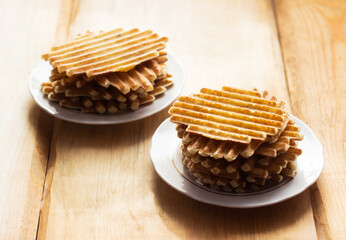 Mashed potato waffles in white plates, wooden background. Food, breakfast