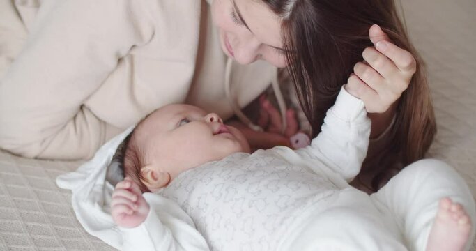 A young mother talks gently to her baby