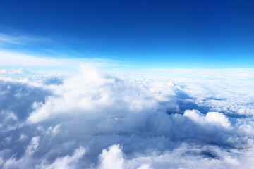 Fototapeta na wymiar Clouds photographed from the plane, high attitude, blue 