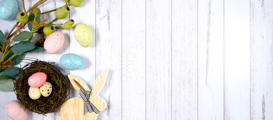 Happy Easter flatlay farmhouse theme banner styled with wood bunny, eggs and eggs against a white wood background with copy space. Sized to fit popular social media and web banner.