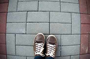 Person taking photo of his feet stand on blank floor, isolated, top view, clipping path. Ground design mock up.