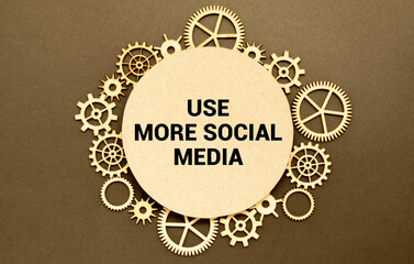 Closeup on businessman holding a card with text USE MORE SOCIAL MEDIA, business concept image