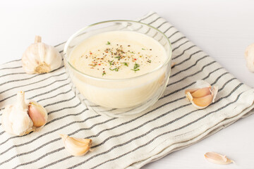garlic sauce on a white table. Universal garlic sauce