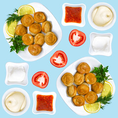 Fried Russian dumplings with three different types of sauce, lemon and tomato. Fried dumplings with meat on a light pastel blue background