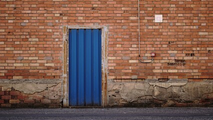 blue door in brick wall