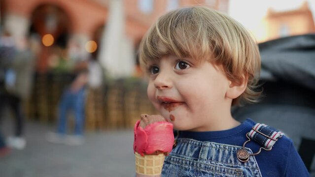 Little boy eating icecream child eats desert
