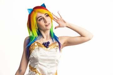 Modernly-looking youthful girl with rainbow hair happily reaching out towards the camera medium studio shot. High quality photo