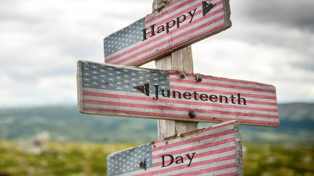 Happy juneteenth day text on wooden american flag signpost outdoors in nature.
