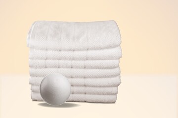 Wool Dryer Balls On White Towel. Eco Friendly Laundry Supplies. Alternative Drying Of Linen.
