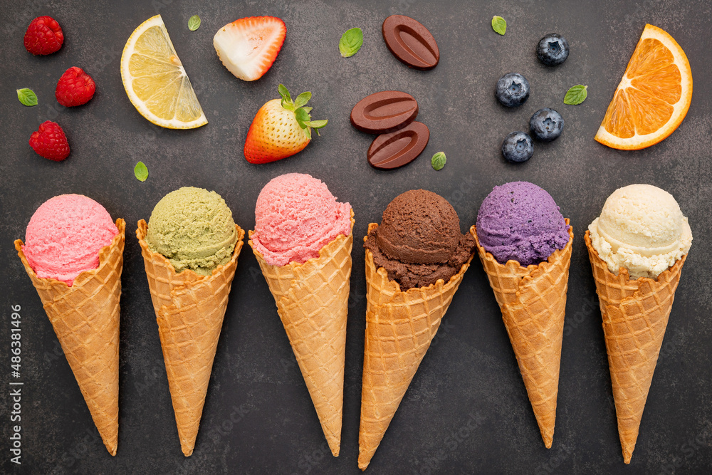 Poster flat lay ice cream cones collection on dark stone background . blank crispy ice cream cone with copy