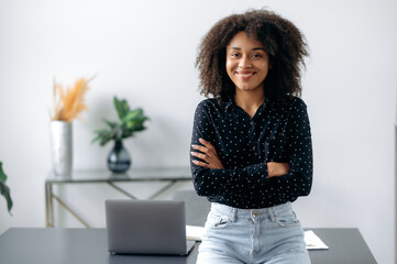 Positive lovely african american girl. Portrait of successful woman, freelancer, manager, stylishly...