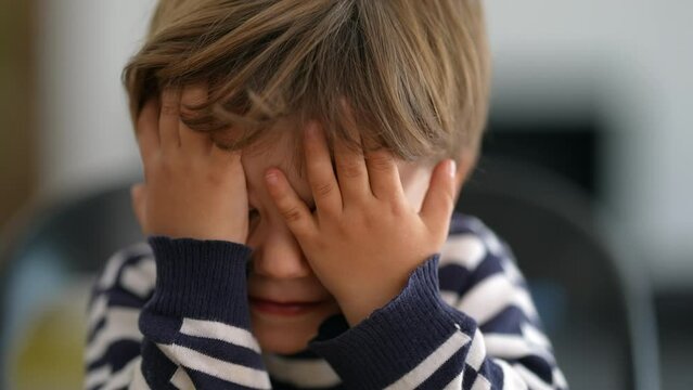 Little boy reaction OH NO covering face with hands