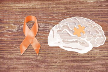 World Multiple Sclerosis Day. Orange awareness ribbon and brain symbol on a background.