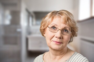 Happy older mature woman portrait. Cheerful elder lady wearing eye glasses