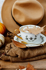 Autumn composition with coffee, autumn leaves, warm sweater and  pumpkins on wooden background, Autumn still life,  Autumn, fall, halloween, thanksgiving day concept.