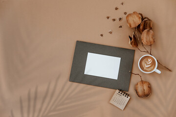 Home office desk workspace. Business, work template. Flat lay, top view. Blank paper sheet, calendar and coffee cup on beige concrete background. Flat Lay - 486388211
