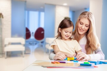 Education and early development concept. Mother helping her daughter with homework