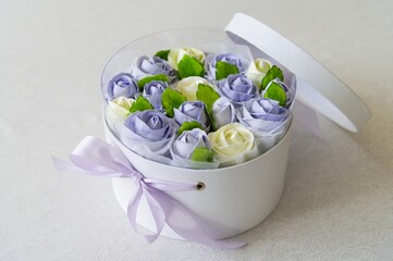 Gift box of purple roses and ivory. Edible flowers, marshmallows. Zefir