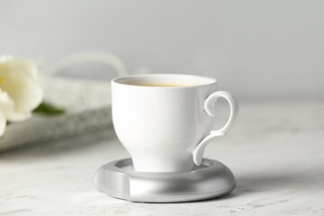 Obraz na płótnie Canvas Cup of coffee with heater on table