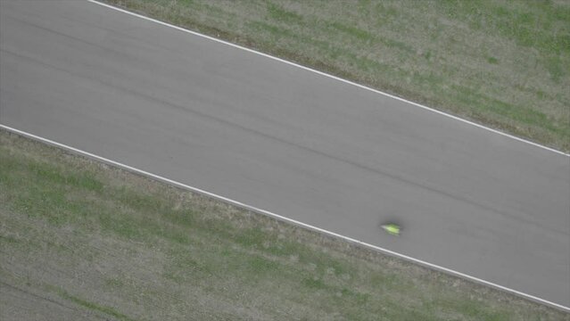 Several motorcycles passing by, seen from above; 25 fps