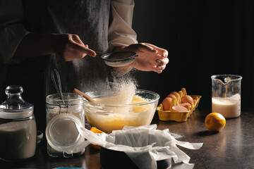 Woman preparing tasty Basque burnt cheesecake in kitchen
