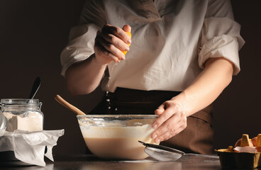 Woman preparing tasty Basque burnt cheesecake in kitchen
