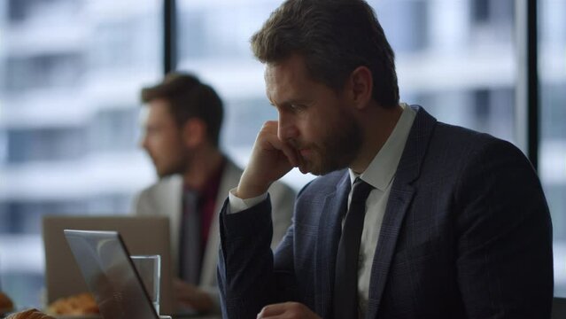 Thinking entrepreneur looking computer screen solving problem in cafe office.