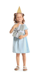 Funny little girl in party hat with gift box on white background