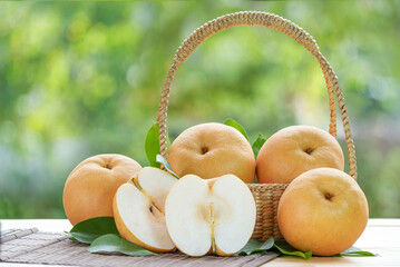 Fresh Nashi pear or Korean pear fruit in the basket over green natural Blur background, Snow pear...