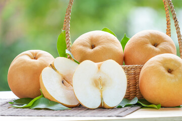 Fresh Nashi pear or Korean pear fruit in the basket over green natural Blur background, Snow pear...