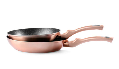 Copper frying pans on white background