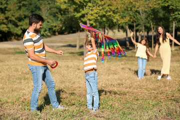 Little boy with kite and his father outdoors