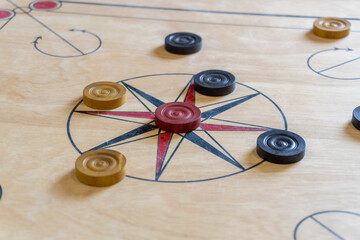 Carrom is a tabletop game of South Asian origin. Carrom is very commonly played by families, including children, and at social functions. - obrazy, fototapety, plakaty
