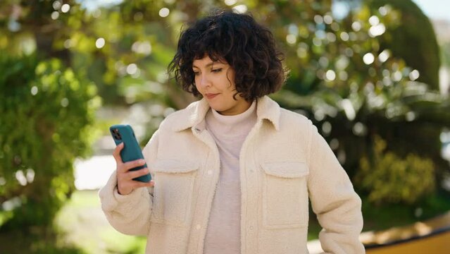 Young hispanic woman smiling confident making selfie by the smartphone at park