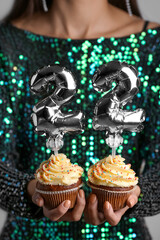 Woman holding Birthday cupcakes with number 22, closeup