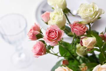 Bouquet of beautiful roses on served table, closeup