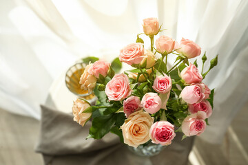 Beautiful bouquet of small roses in light room