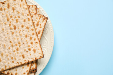 Plate with Jewish flatbread for Passover on color background