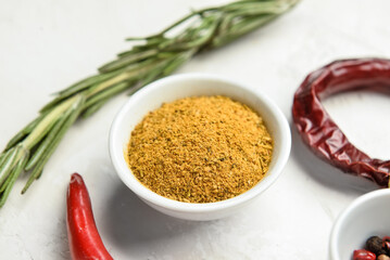 Bowl with aromatic spices on light background, closeup