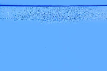 Naklejka na ściany i meble Clear water with air bubbles on blue background