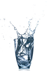 Glass of clear water with splash isolated on white