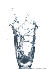 Glass of clear water with splash isolated on white