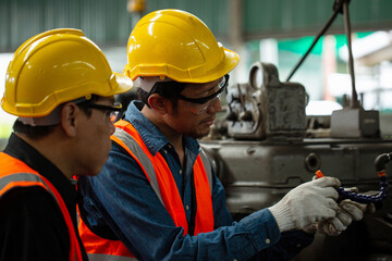 Two Asian worker check status task  in production line