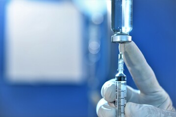 syringe needle injected in drug bottle