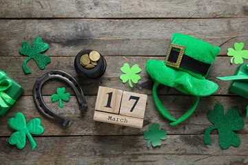 Leprechaun pot with golden coins, hat, horseshoe and calendar with date of St. Patrick's Day on...