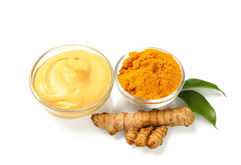 Bowls with turmeric mask and powder on white background